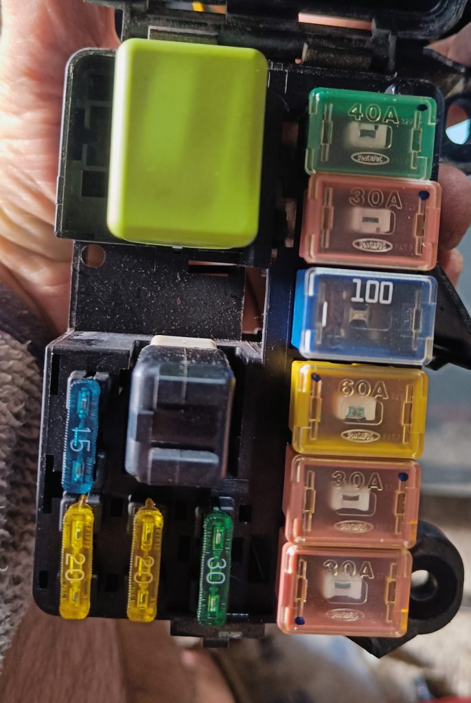 Image of fuses and relays insdie engine fuse box.