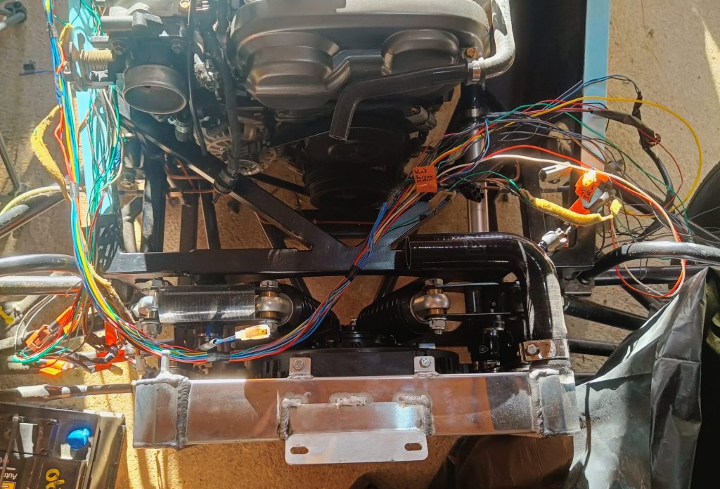 Image of front N/S loom laid onto chassis ready to connect to headlight etc.