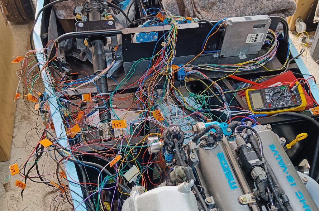 Image of wiring being fitted to car. Both OEM fuse boxes removed and wiring further simplified - for now!
