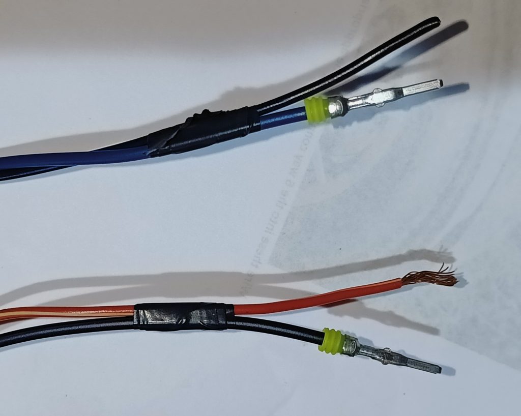 Image of two headlamp wires and their Mazda partners.