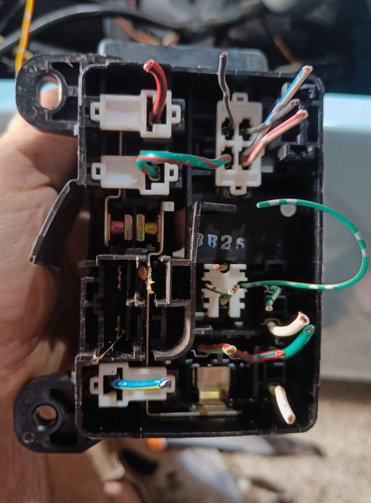 Image of underside of engine fuse box once connector X-10 has been removed.